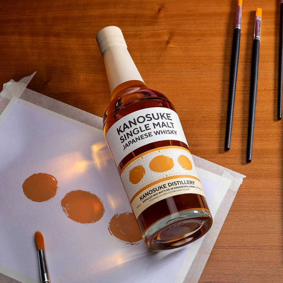 Kanosuke 2018 Bourbon Cask 19044 Peated 700ml bottle beside brush stroke test swatches, Brush Stroke series, Kanosuke Distillery Kagoshima Japan