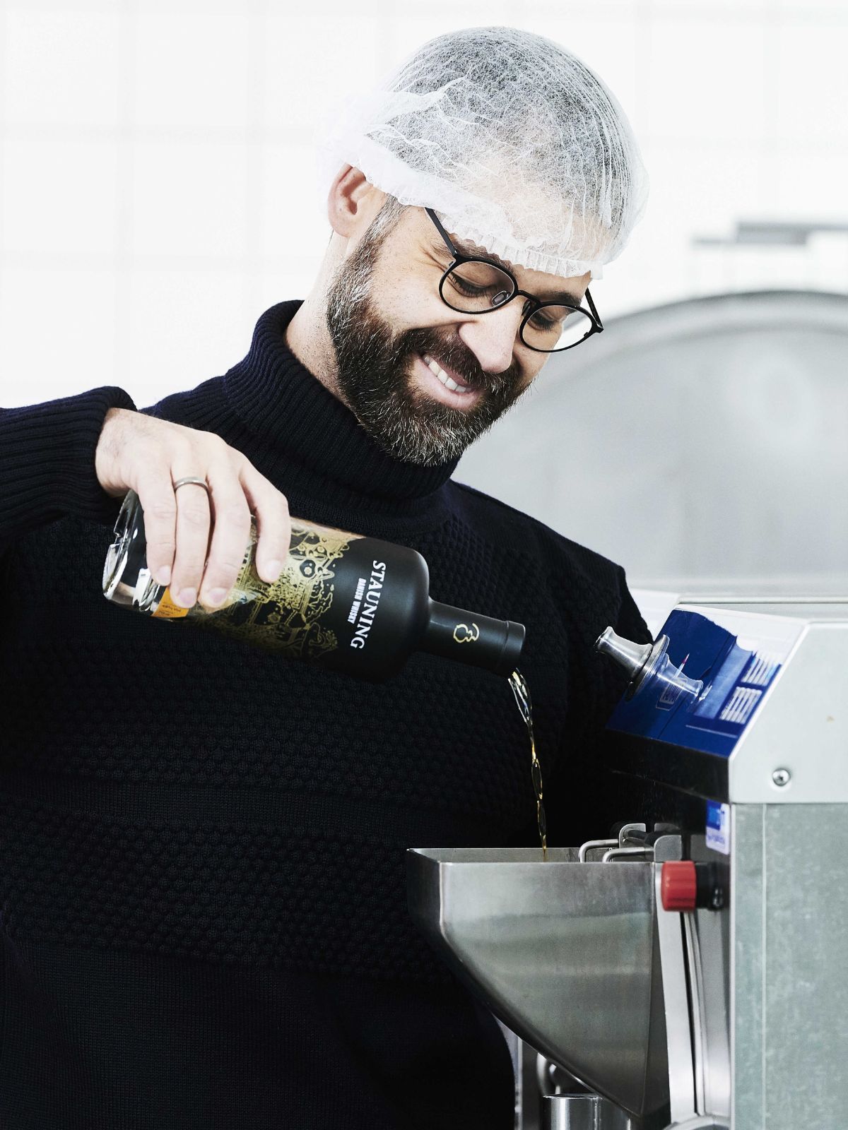 Alex Ice cream maker pouring Stauning whisky into the machine to make cask-strength Stauning whisky ice cream