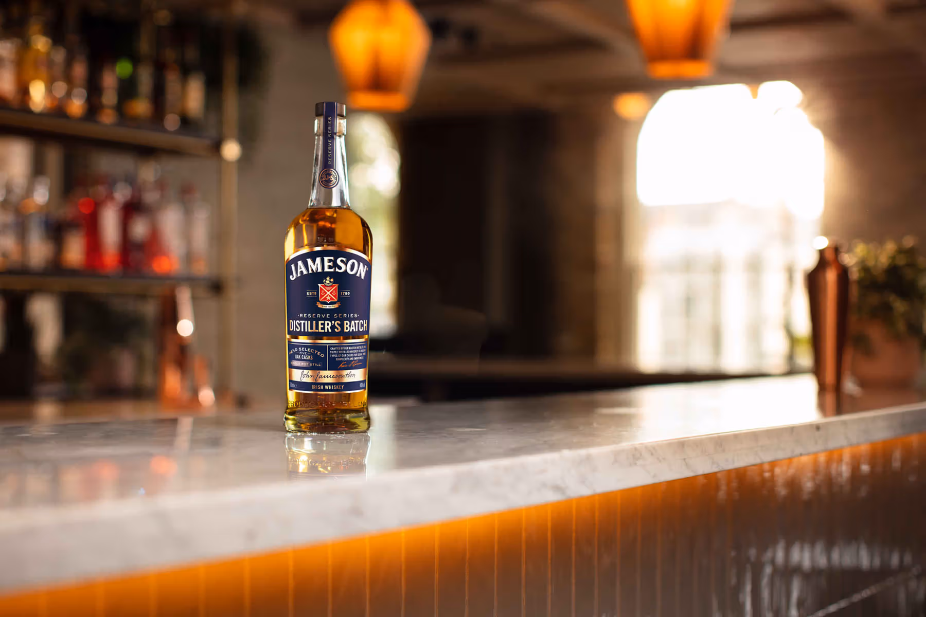 Jameson Distiller's Batch 700ml bottle on driftwood surrounded by chocolate, cinnamon, ginger, orange and caramel, Reserve Series single pot still Irish whiskey 2026"