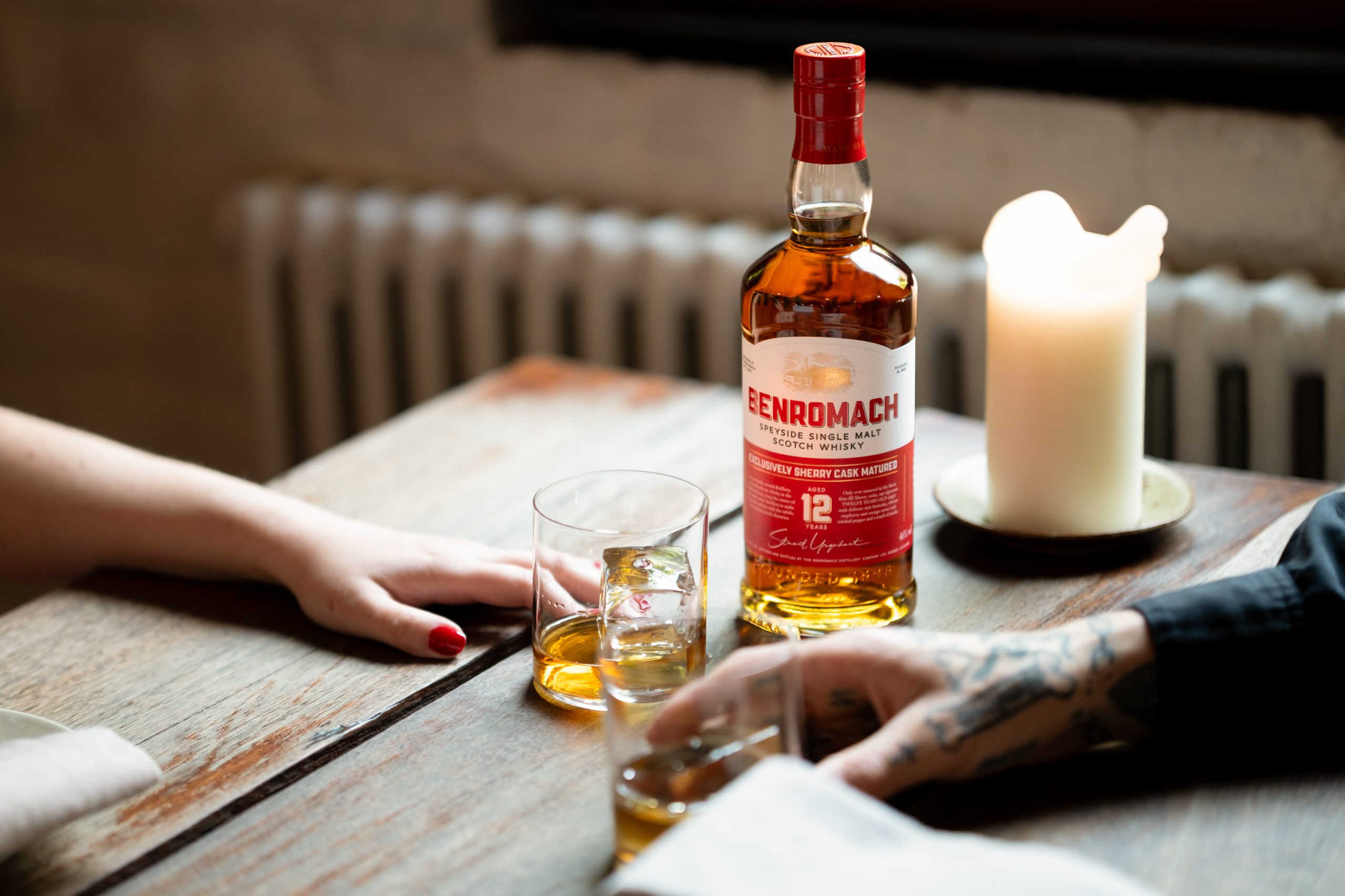Benromach 12 Years Old 700ml bottle on a wooden table beside a filled whisky glass and candle, first-fill Sherry cask matured Speyside single malt, 2026