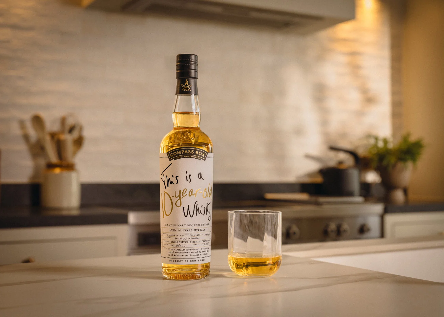Compass Box This is a 10-Year-Old Whisky bottle beside a tumbler of whisky on a kitchen counter, blended malt Scotch 2026