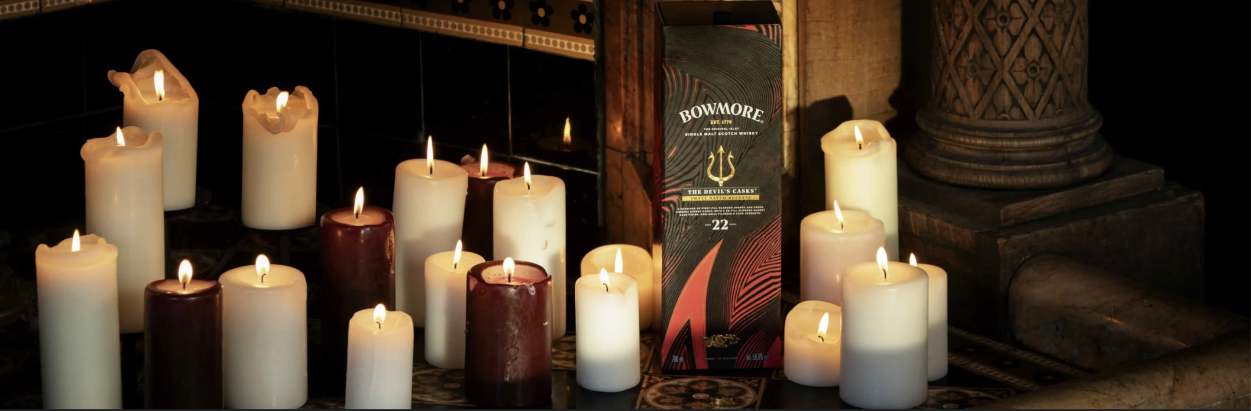 Bowmore Devil’s Casks 22 Year Old gift box surrounded by lit candles, limited Islay release 2026